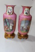 Pair Sevres vases having panels of figure and flower decoration on pink ground,