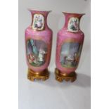 Pair Sevres vases having panels of figure and flower decoration on pink ground,