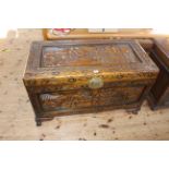 Oriental carved trunk, 62cm by 101cm by 52cm.