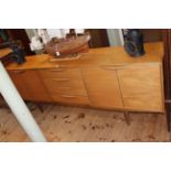 Teak Long John sideboard having four central drawers flanked by four cupboard doors,
