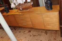 Teak Long John sideboard having four central drawers flanked by four cupboard doors,