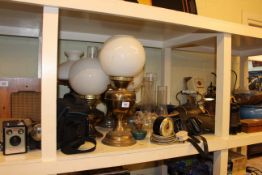 Full shelf of oil lamps, metalwares, cycle parts, walking canes, musical instruments and parts, etc.