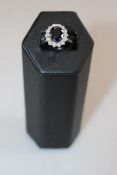 18 carat white gold, sapphire and diamond cluster ring, having 3.76 carat oval sapphire, size N.