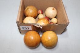 Box with six ivory billiard balls and five small balls.