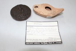 Roman terracotta oil lamp, 10.5cm across and resin replica coin weight (2).