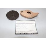 Roman terracotta oil lamp, 10.5cm across and resin replica coin weight (2).