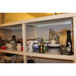 Full shelf including picnic hamper, pictures, brassware, crockery, glassware, Meerkat figures, etc.