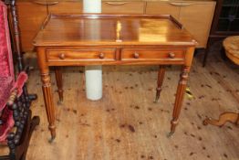 Victorian mahogany two drawer side table on circular tapering fluted legs, 80cm by 99cm by 55cm.