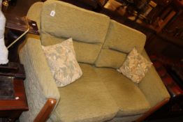 Ercol two seater settee in sage green fabric.