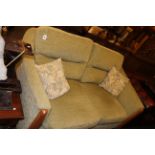 Ercol two seater settee in sage green fabric.