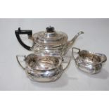 George IV silver three piece tea set with embossed decoration, Sheffield 1913.