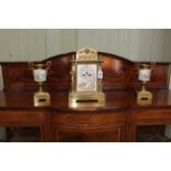 Continental porcelain and brass three piece garniture clock set.