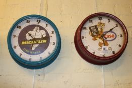 Two reproduction advert wall clocks.