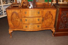 Walnut serpentine front sideboard on ball and claw legs, 105.5cm by 135cm by 52cm.