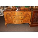 Walnut serpentine front sideboard on ball and claw legs, 105.5cm by 135cm by 52cm.