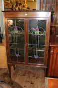 Art Nouveau mahogany and line inlaid leaded glass two door vitrine bearing label for Snowballs Ltd,