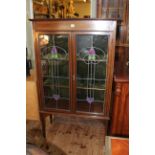 Art Nouveau mahogany and line inlaid leaded glass two door vitrine bearing label for Snowballs Ltd,