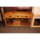 Light oak three drawer console table with undershelf, 81cm by 151cm by 45cm.