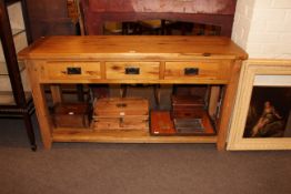 Light oak three drawer console table with undershelf, 81cm by 151cm by 45cm.