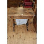 Victorian rosewood sewing table of serpentine form having fitted frieze drawer above a deep drawer,