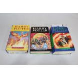 Three first edition Harry Potter books.