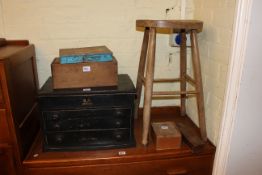 Elm stool, three drawer table cabinet, two boxes of printing type,