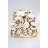 Royal Albert Country Roses tableware, thirty eight pieces including teapot, sugar and cream.