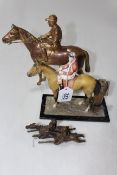 Three metal equestrian pieces, table lighter, horse and jockey, and pair of steeplechasers,