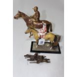 Three metal equestrian pieces, table lighter, horse and jockey, and pair of steeplechasers,