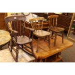 Three elm seated child's chairs including one rocker.