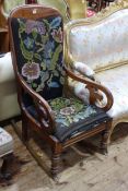 Victorian mahogany scroll arm rocking chair in floral needlework.