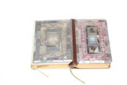 Two ornate mother of pearl veneered Prayer books, largest 12cm by 8.5cm.
