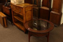 Serpentine front side cabinet having deep drawer above open shelves and glass inset circular coffee