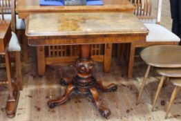 Victorian walnut fold top card table on turned carved pedestal to four scrolled legs,