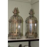 Pair of gilded metal and glazed hall lanterns in cylindrical form with dome tops.