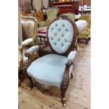 Victorian carved mahogany oval panel back open armchair.