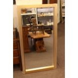 Rectangular gilt framed bevelled wall mirror, 132cm by 70cm.