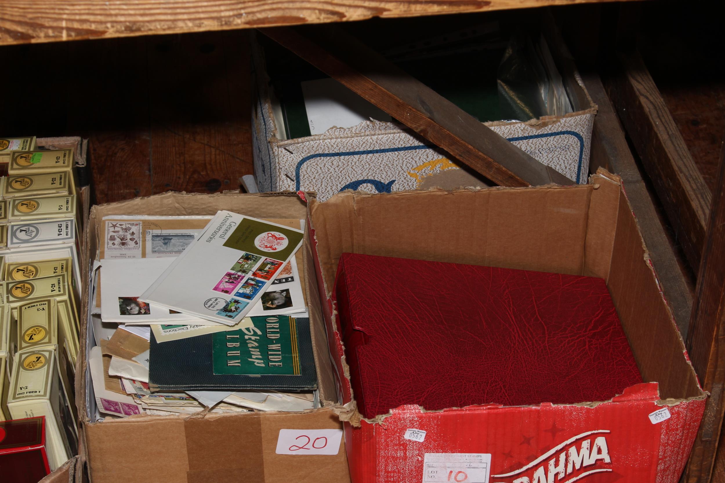 Three boxes of assorted stamps and albums.