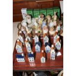 Fourteen Royal Albert Beatrix Potter characters and fourteen Bols houses.