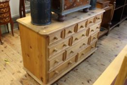 Pine thirteen drawer chest on turned feet, 86cm by 130cm by 50cm.