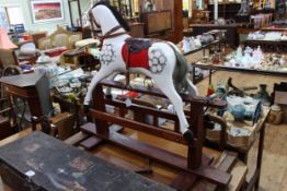 Small sponge painted rocking horse on stained safety stand, 93cm by 111cm.