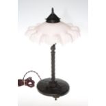 Art Nouveau period cast metal column table lamp with pink opaque fancy shade, 44cm.