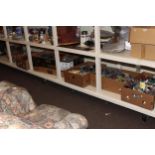 Full shelf of assorted toys including Lego, baby walkers, model railway buildings, fort,