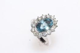18 carat white gold, blue topaz and diamond cluster ring, having 8 carat oval blue topaz, size N.