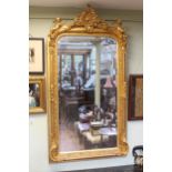 Good gilt framed rectangular bevelled wall mirror with foliate crest flanked by cherubs,