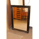 Rectangular black swept frame bevelled wall mirror, 106cm by 75cm.