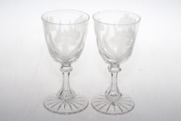Pair of large wine goblets, the bowls etched with flowers and on hexagonal stems, 19cm.