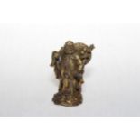 Chinese gilt bronze travelling elder, 9.5cm.