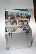 Case of Beatles vinyl records including Sgt Peppers Club Band, red and blue vinyls,