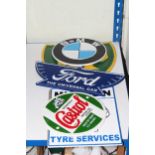 Five cast metal advertising signs 'Castrol', 'Michelin', 'BP', 'Ford' and 'BMW'.
